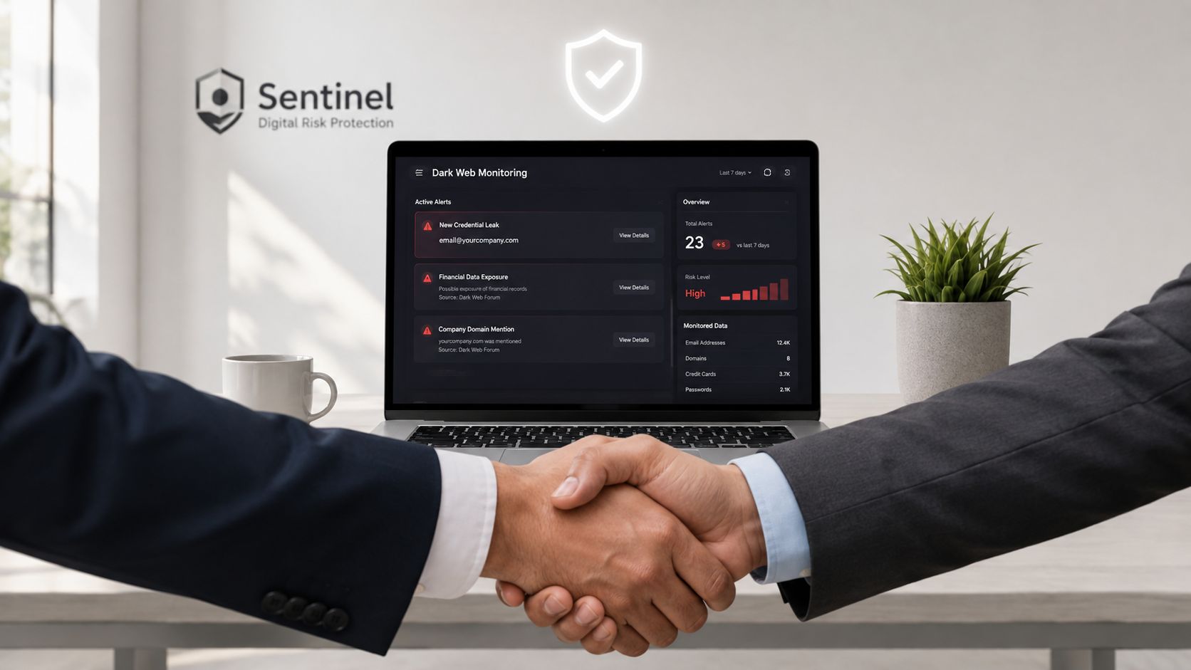 Two business partners shaking hands in front of a laptop showing a dark web monitoring dashboard.